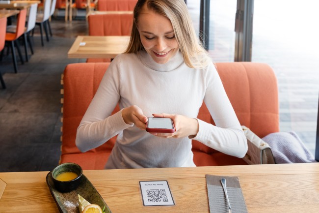 Woman Scanning QR Code